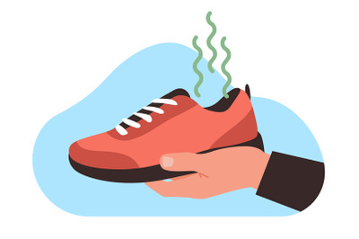 Man holds his shoes in his hand with very bad and unpleasant odor. Sme