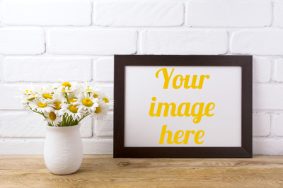 Black brown  landscape frame mockup with chamomile bouquet in rustic vase
