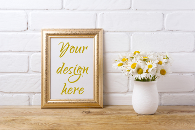 Golden  frame mockup with chamomile bouquet in rustic vase.