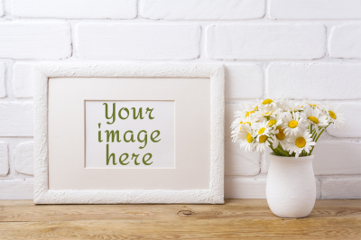 White landscape frame mockup with chamomile bouquet in rustic vase.