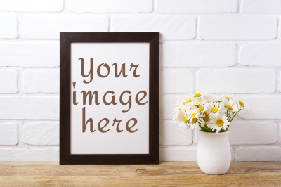 Black brown frame mockup with chamomile bouquet in rustic vase.
