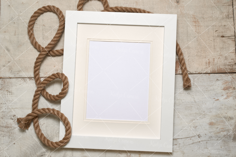 r-frame-with-rope-on-rustic-white-barn-wood-background