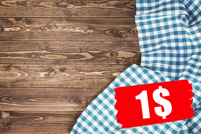 blue-checkered-tablecloth-on-wooden-table-top-view