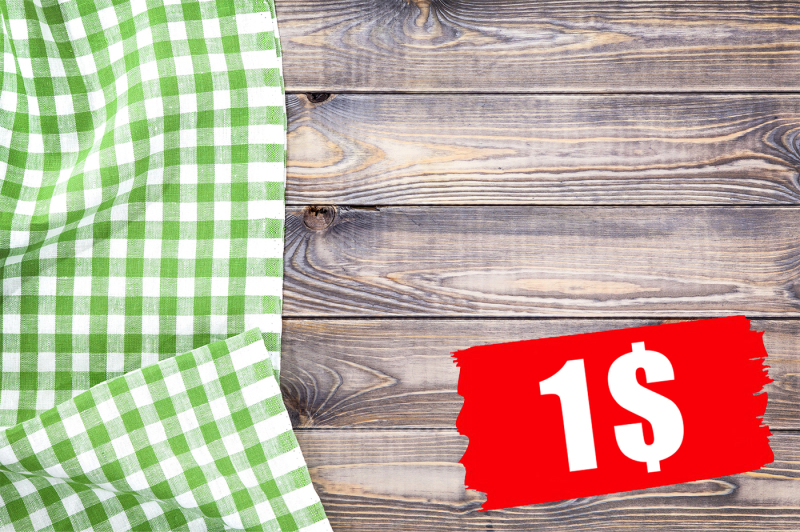 green-checkered-tablecloth-on-wooden-table-top-view