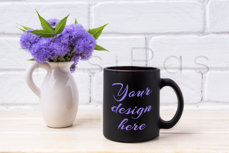 black-coffee-mug-mockup-with-blue-ageratum-in-pitcher