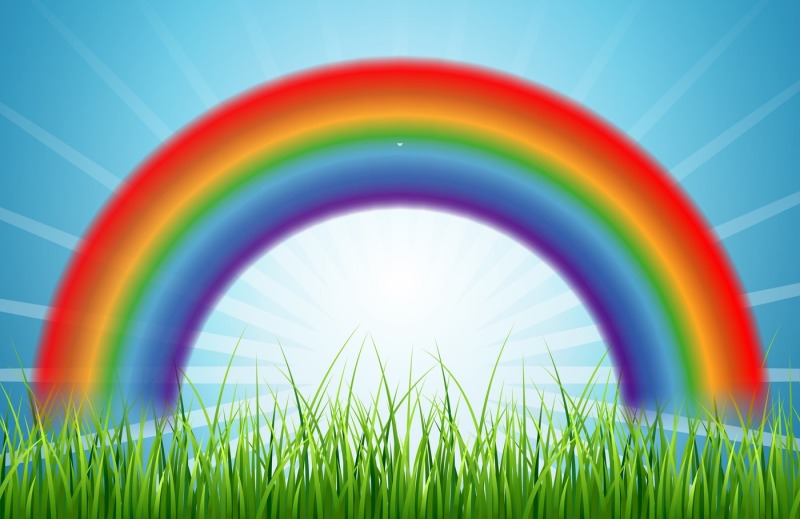 bright-rainbow-blue-sky-with-rising-sun-and-green-grass