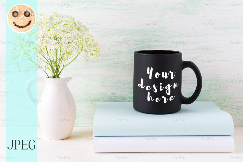 black-coffee-mug-mockup-with-books-and-tender-white-flowers