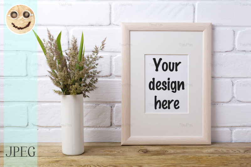 wooden-frame-mockup-with-grass-and-green-leaves-in-cylinder-vase