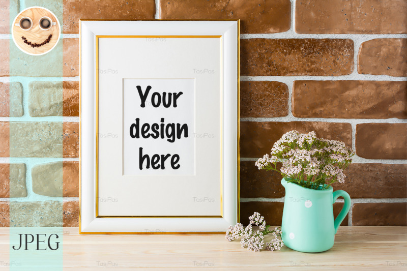 gold-decorated-frame-mockup-soft-pink-flowers-exposed-brick-wall