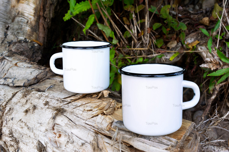 two-white-campfire-enamel-mug-mockup-with-tree-stump