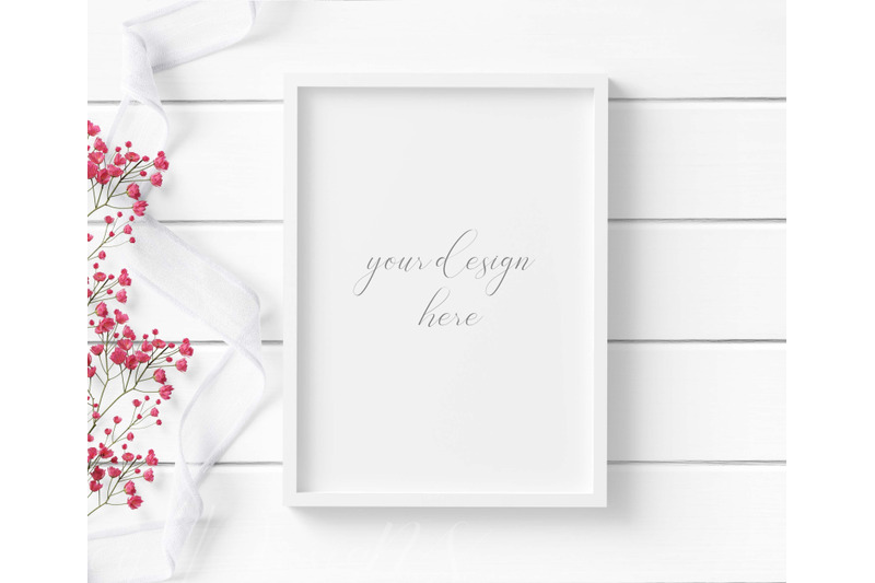 5x7-white-frame-mockup-with-white-ribbon-amp-red-flowers-on-white-wood