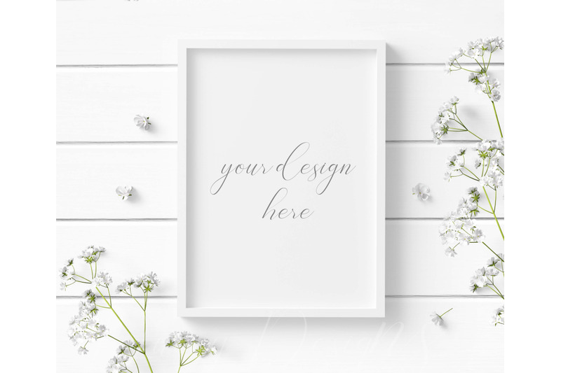 5x7-white-frame-mockup-with-white-flowers-on-a-white-wood-background