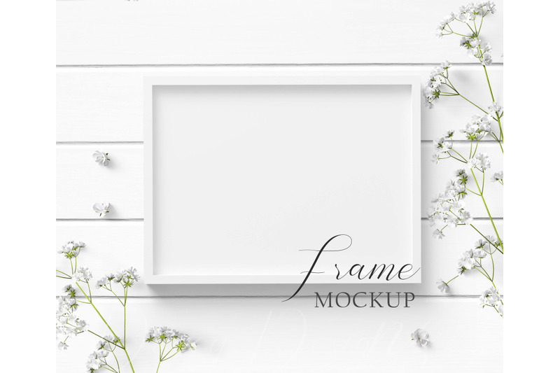 5x7-white-frame-mockup-with-white-flowers-on-a-white-wood-background