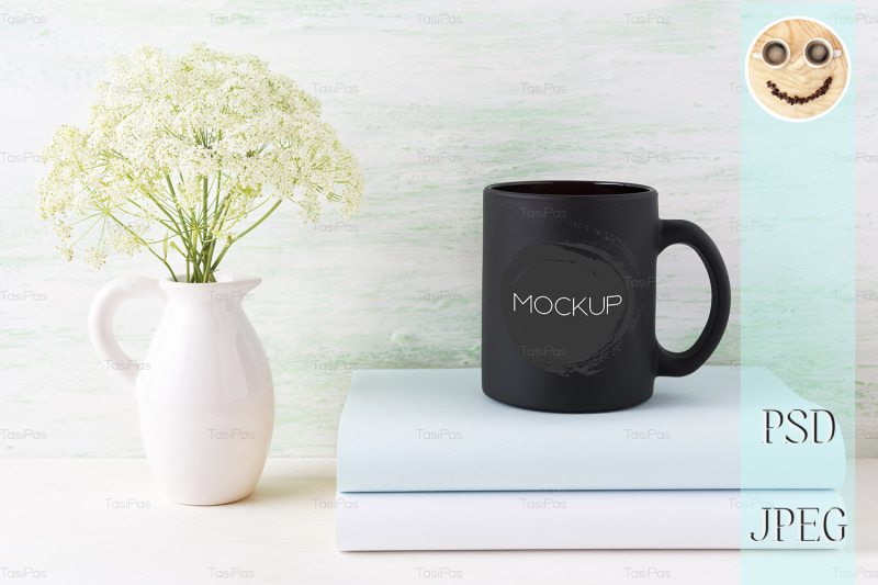 black-coffee-mug-mockup-with-books-and-tender-white-flowers