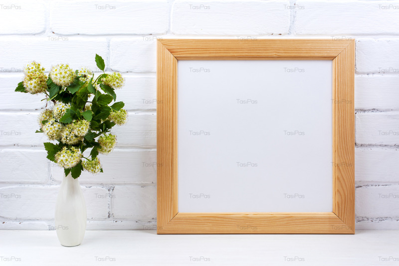 square-wooden-picture-frame-mockup-with-white-spirea