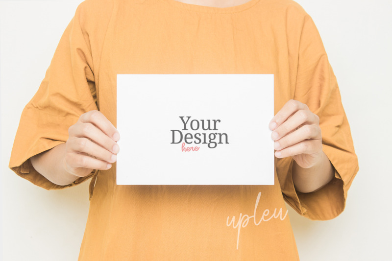 a5-greeting-card-mockup-model-handling-a5-card-mockup-with-dress