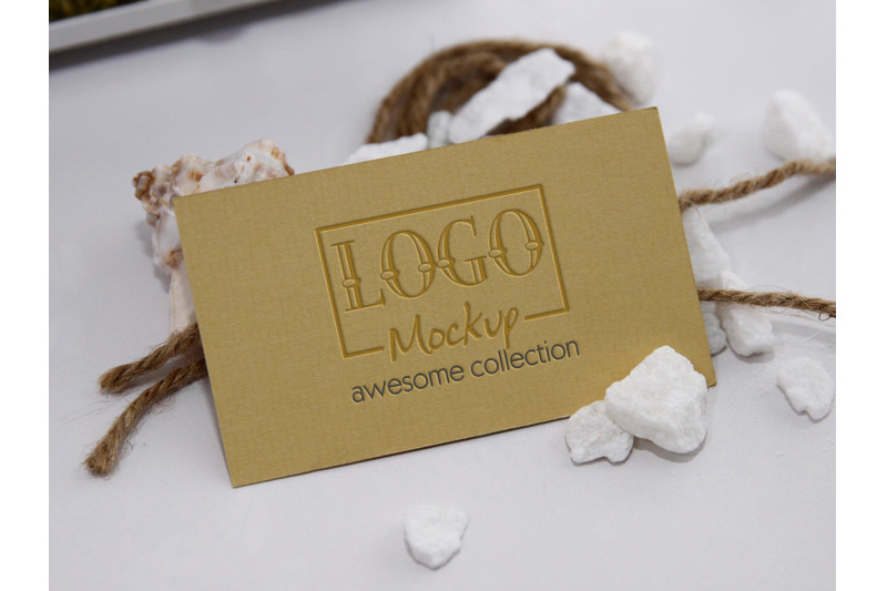 logo-mockup-with-white-stones-and-seashels-design