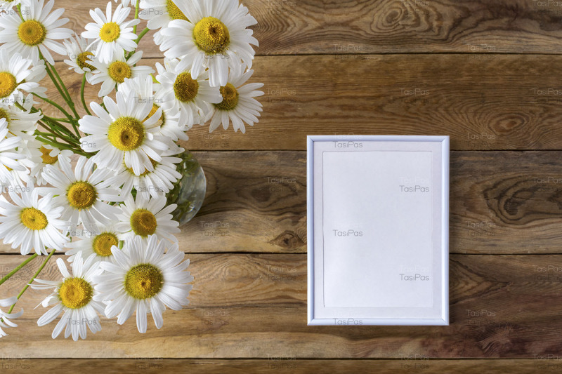 white-small-frame-mockup-with-daisy-wildflowers