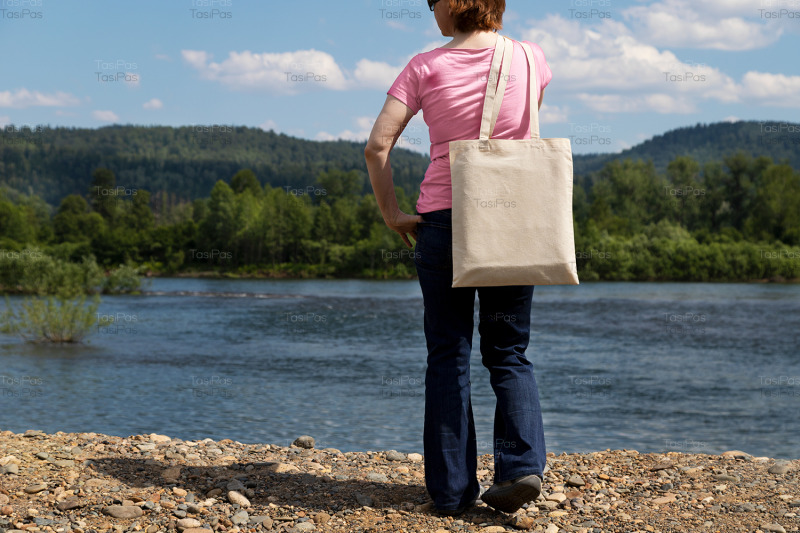 woman-holding-tote-bag-mockup-river-bank