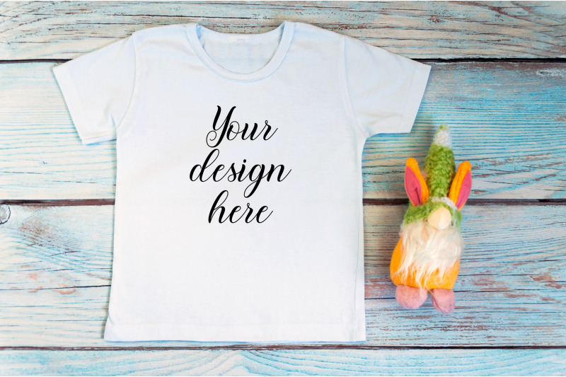 kids-white-t-shirt-mockup-with-gnomes-on-a-wooden-background