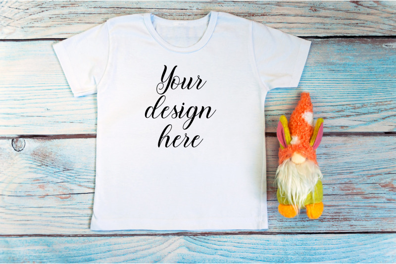 kids-white-t-shirt-mockup-with-gnomes-on-a-wooden-background