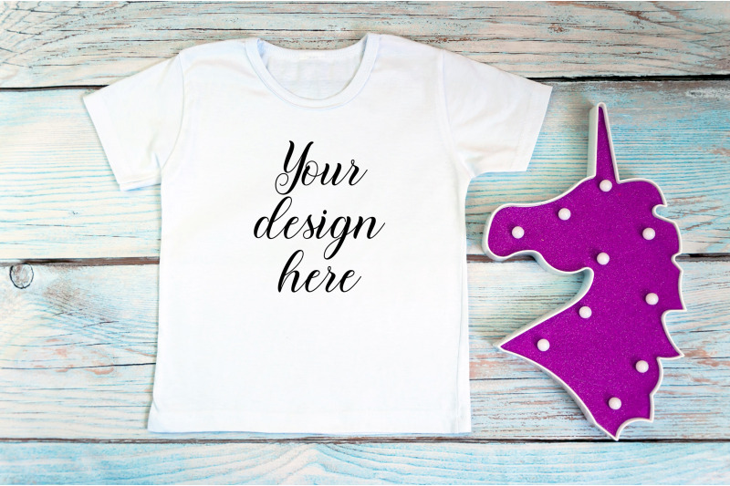 kids-white-t-shirt-mockup-with-unicorn-toy-on-a-wooden-background