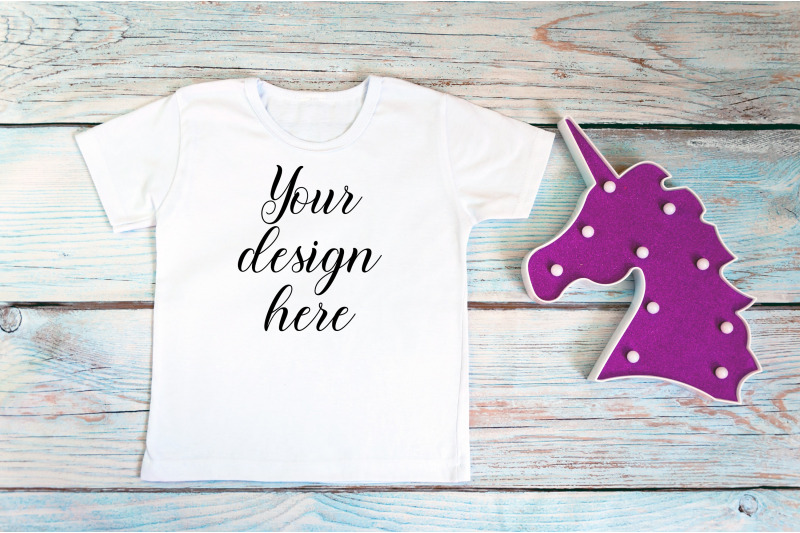 kids-white-t-shirt-mockup-with-unicorn-toy-on-a-wooden-background