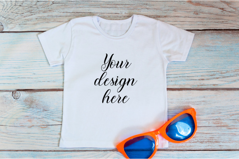 kids-t-shirt-mockup-with-sunglasses-on-a-wooden-background