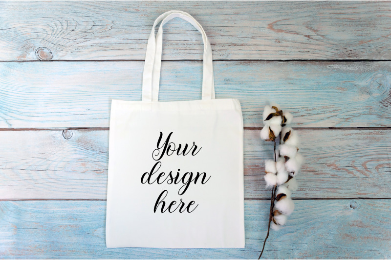 white-tote-bag-mockup-with-cotton-flowers-on-a-wooden-background