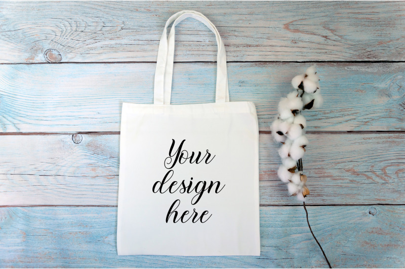 white-tote-bag-mockup-with-cotton-flowers-on-a-wooden-background