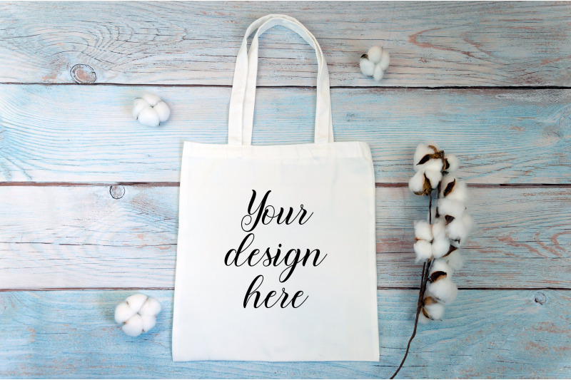 white-tote-bag-mockup-with-cotton-flowers-on-a-wooden-background