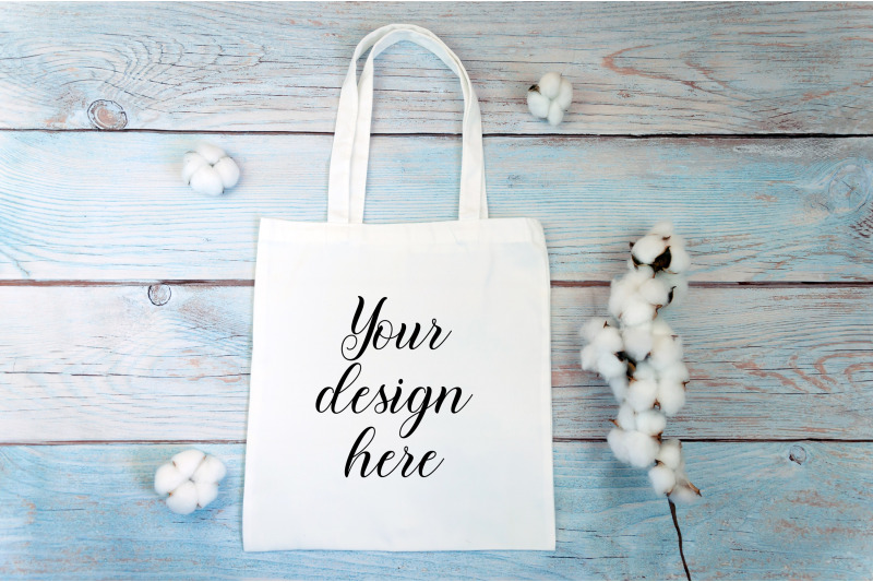 white-tote-bag-mockup-with-cotton-flowers-on-a-wooden-background