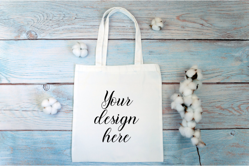 white-tote-bag-mockup-with-cotton-flowers-on-a-wooden-background