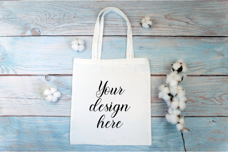 white-tote-bag-mockup-with-cotton-flowers-on-a-wooden-background