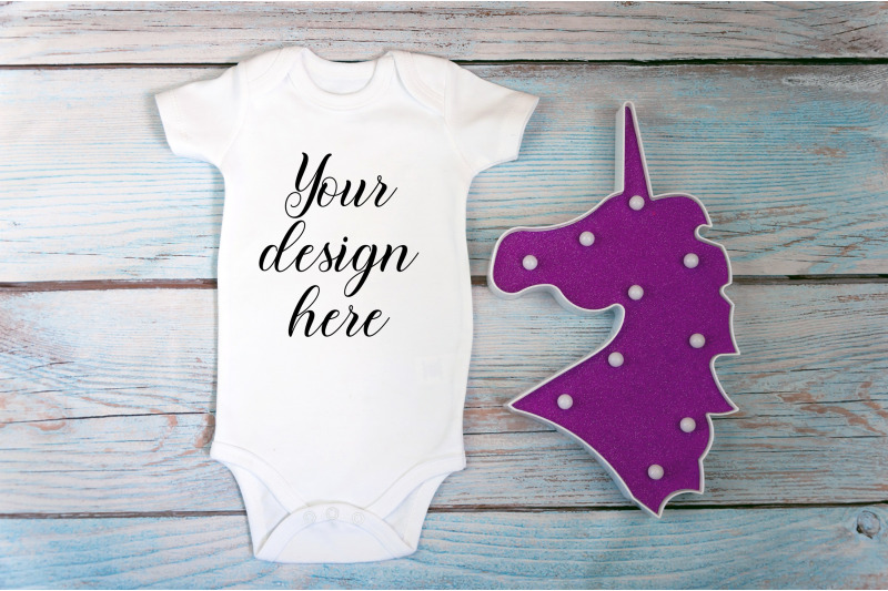 baby-bodysuit-mockup-with-toy-on-a-wooden-background