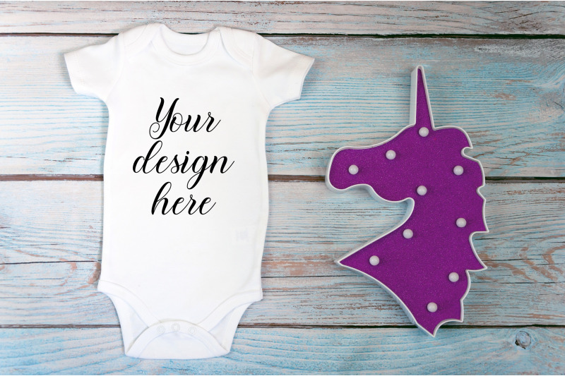 baby-bodysuit-mockup-with-toy-on-a-wooden-background