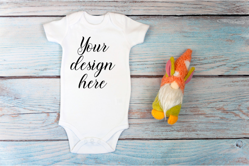 baby-bodysuit-mockup-with-toy-on-a-wooden-background