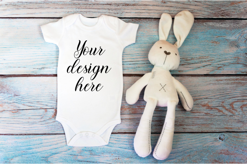 baby-bodysuit-mockup-with-toy-on-a-wooden-background