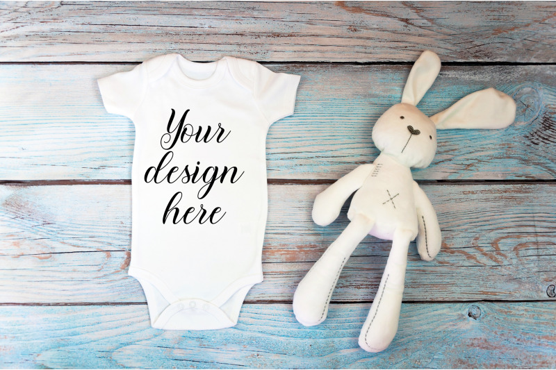 baby-bodysuit-mockup-with-toy-on-a-wooden-background