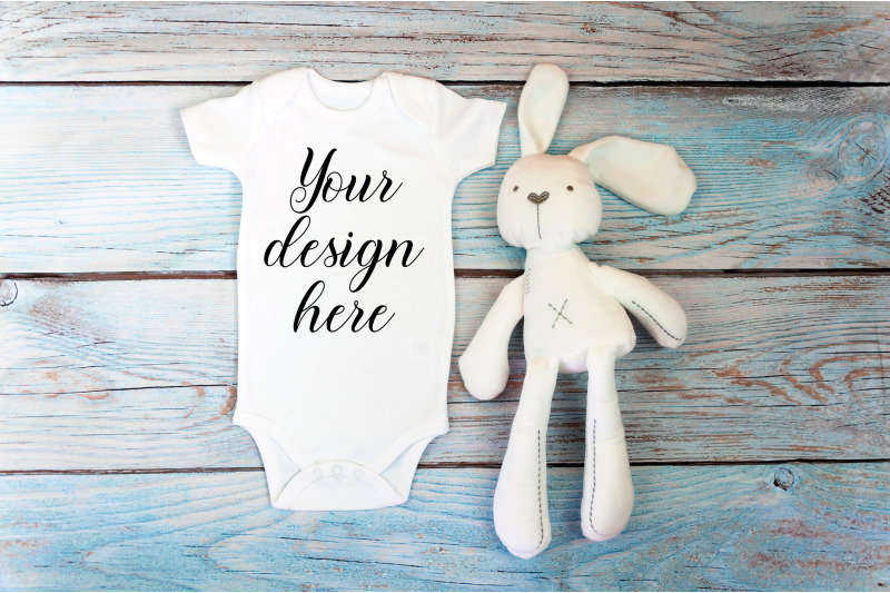 baby-bodysuit-mockup-with-toy-on-a-wooden-background