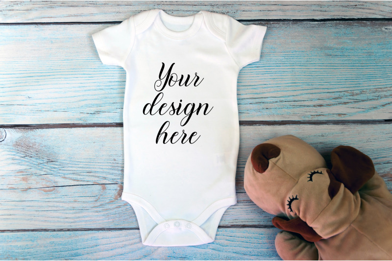 baby-bodysuit-mockup-with-toy-on-a-wooden-background