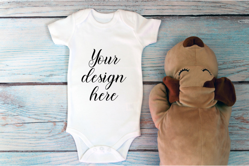 baby-bodysuit-mockup-with-toy-on-a-wooden-background