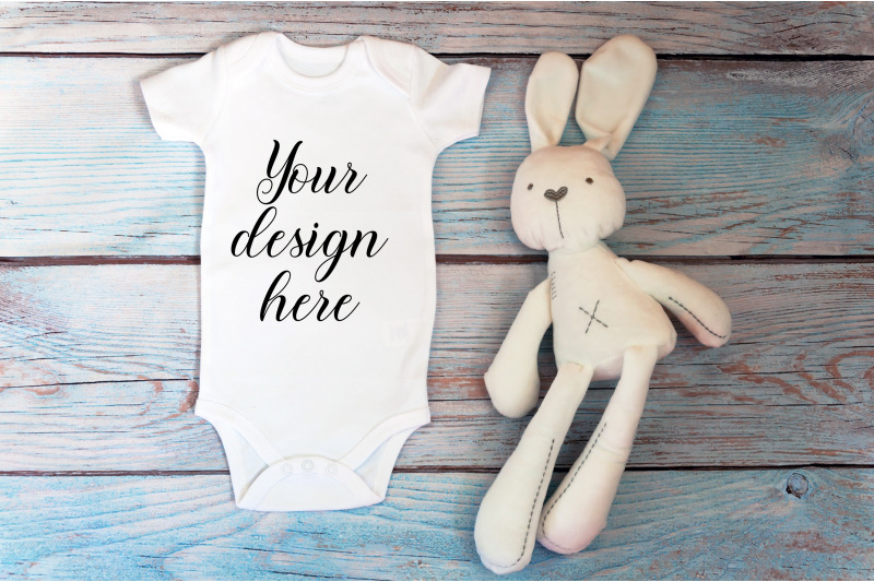 baby-bodysuit-mockup-with-toy-on-a-wooden-background