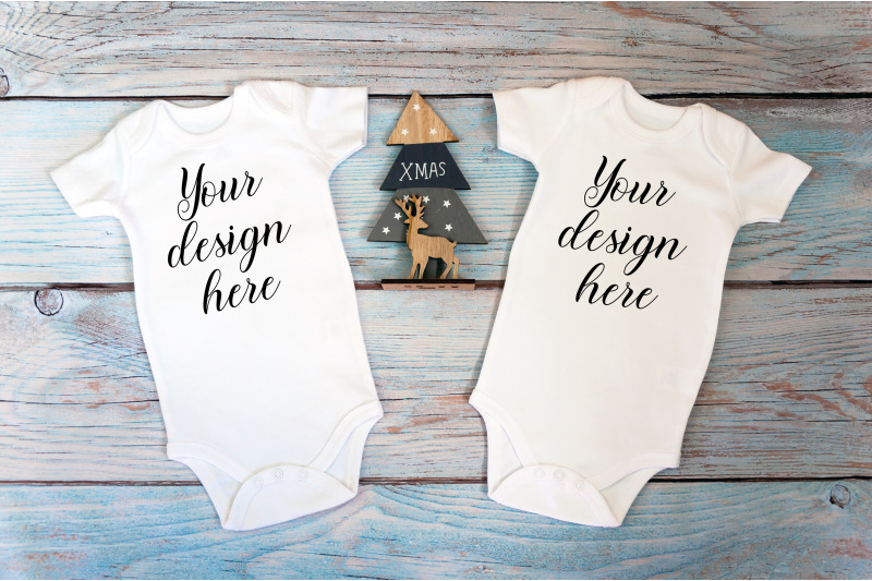 two-christmas-baby-bodysuits-mockup-on-a-wooden-background