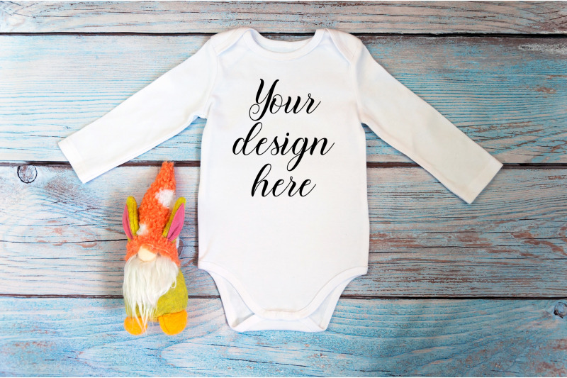 baby-bodysuit-mockup-with-gnome-toy-on-a-wooden-background