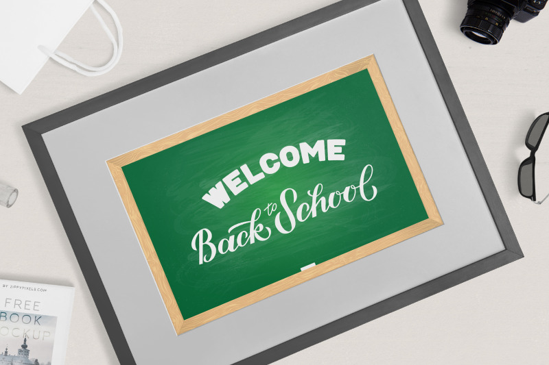 welcome-back-to-school-hand-lettering-on-green-board-with-wooden-frame