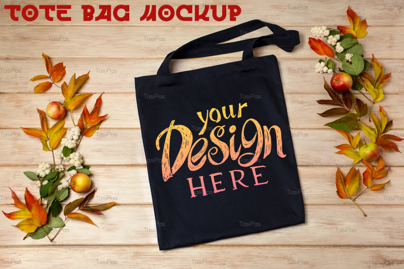 black-tote-bag-mockup-with-fall-leaves-and-snowberry