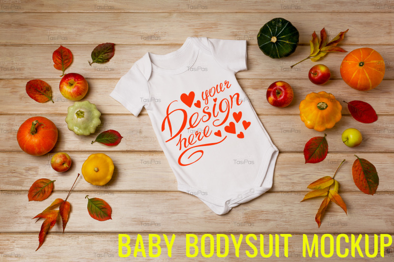 white-baby-short-sleeve-bodysuit-mockup-with-fall-decor