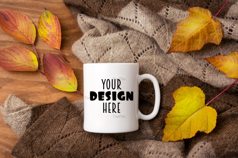 white-coffee-mug-mockup-with-knitted-blanket-and-fall-colorful-leaves