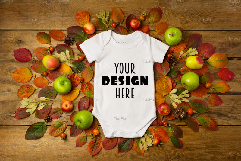 white-baby-short-sleeve-bodysuit-mockup-with-fall-leaves-and-pine-cone